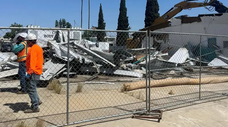 Alliance crew on a commercial demolition site behind safety fencing